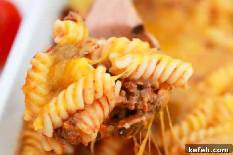 30 Ground Beef Dinner Recipes for Quick Family Meals 5 closeup of the Cheeseburger Casserole on a wooden spoon.