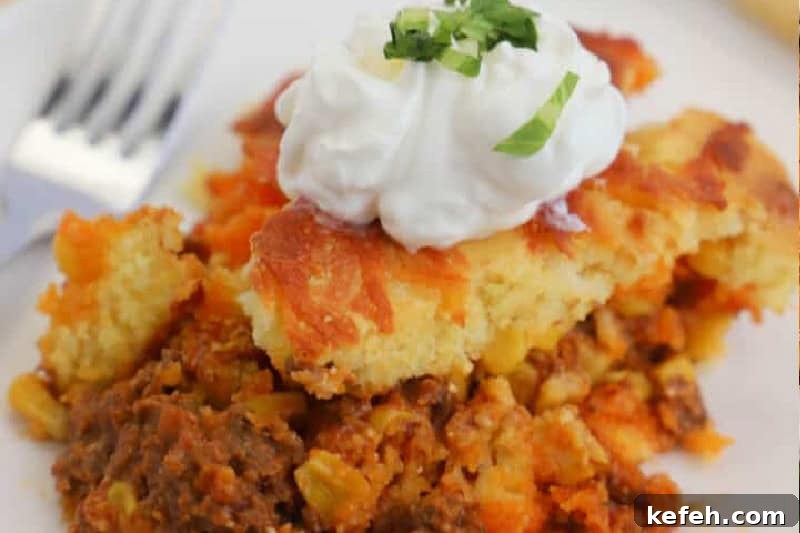 30 Ground Beef Dinner Recipes for Quick Family Meals 8 closeup of the Taco Cornbread Casserole on a white plate.