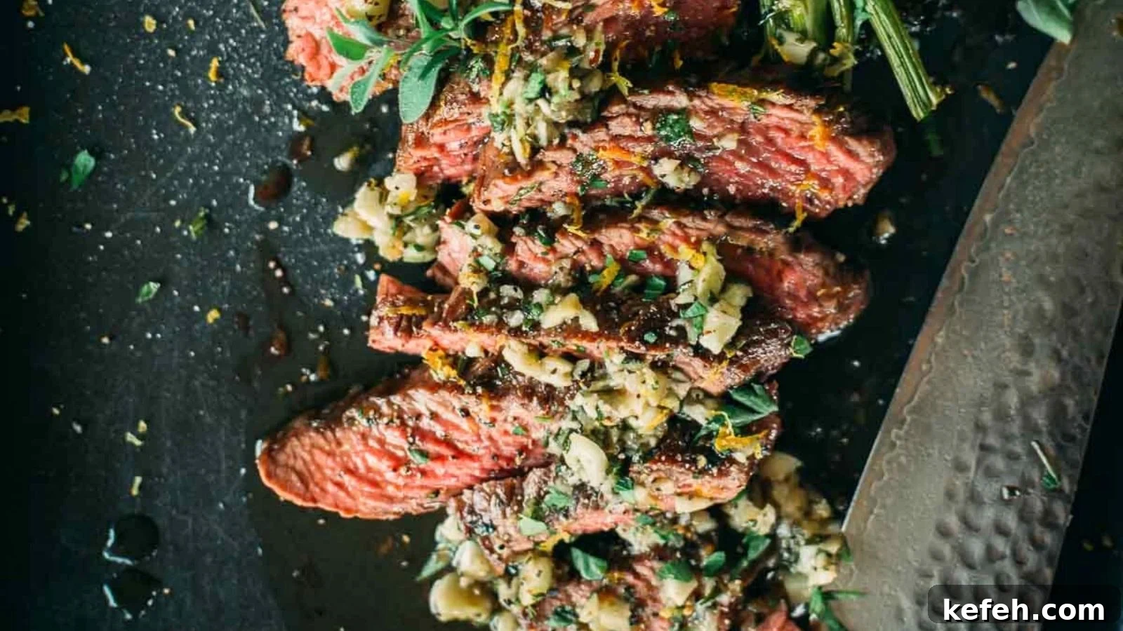 17 Budget-Friendly Steak Recipes to Feed a Crowd Without Breaking the Bank 15 Garlic butter basted teres major steak sliced to show juicy interior with butter pooling beneath.