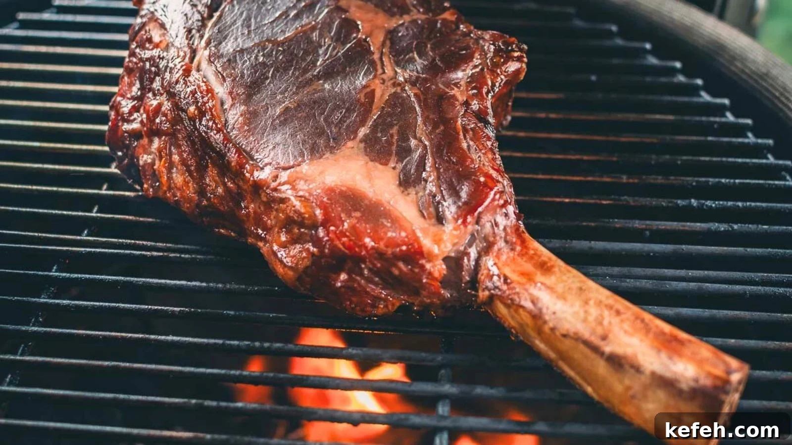 17 Budget-Friendly Steak Recipes to Feed a Crowd Without Breaking the Bank 3 Grilled cowboy steak with deep char marks and thick juicy slices fanned across a board.