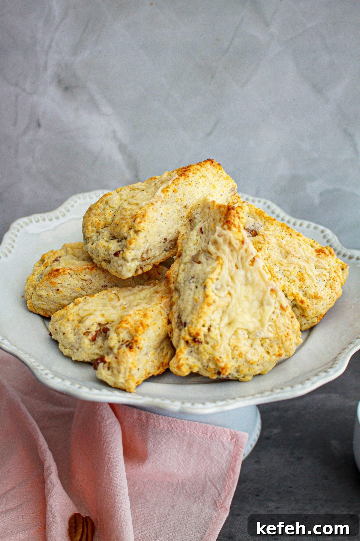 white cheddar scones stacked on a plate.