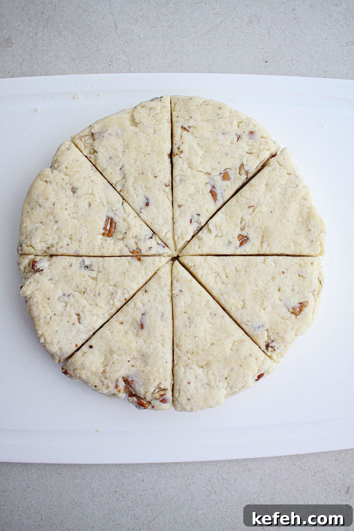 dough on parchment paper being cut into triangles.