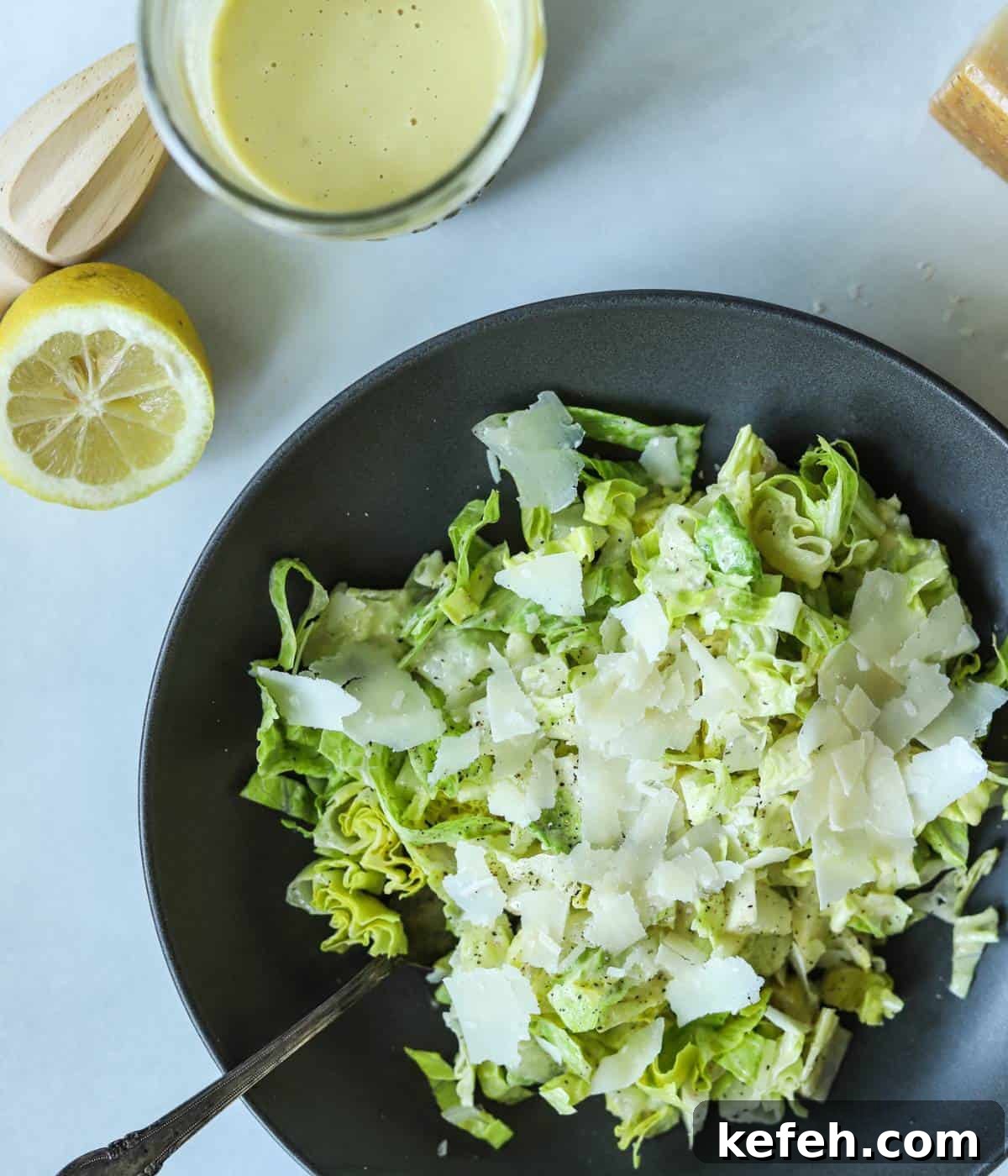 Creamy Caesar Salad Dressing Without Anchovies or Raw Eggs 2 Caesar salad topped with caesar dressing with no anchovies in bowl.