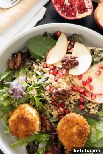 fall salad topped with fried goat cheese balls