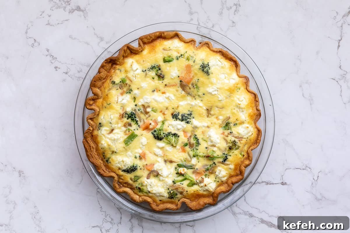 baked salmon and broccoli quiche in pie pan.