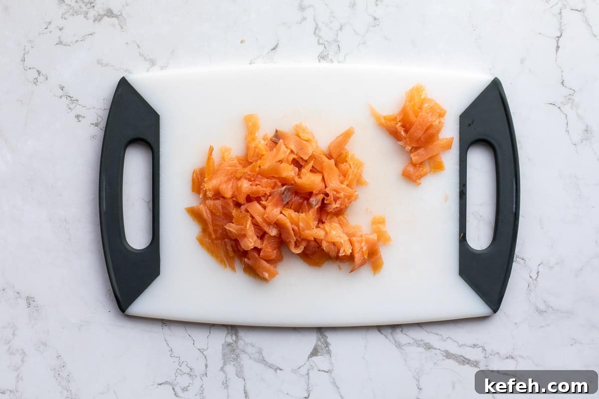 chopped smoked salmon on cutting board.