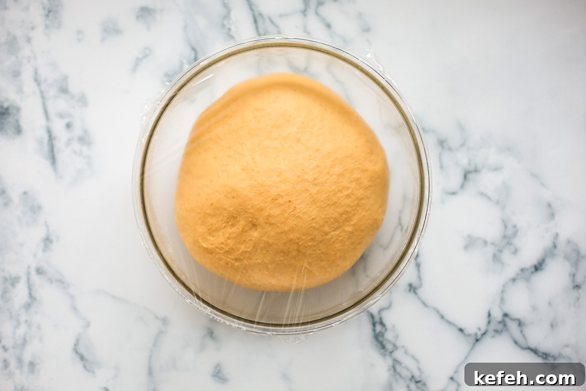 Puffy dough inside glass bowl.