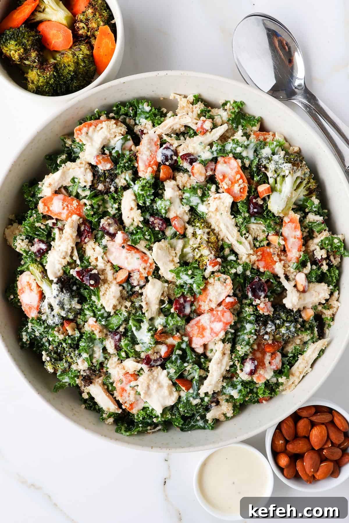 Kale and broccoli salad with chicken in a bowl.