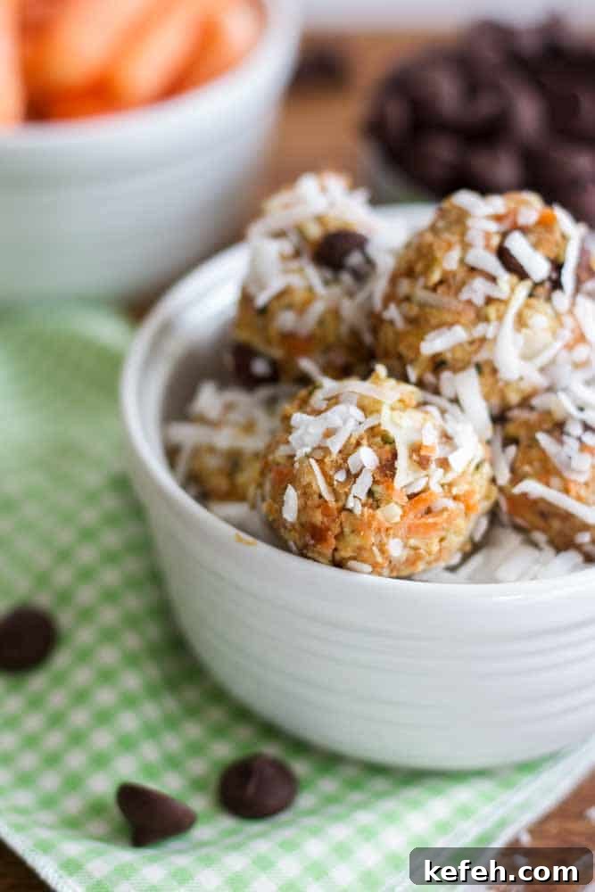white bowl on a table filled with carrot cake energy balls covered in coconut flakes