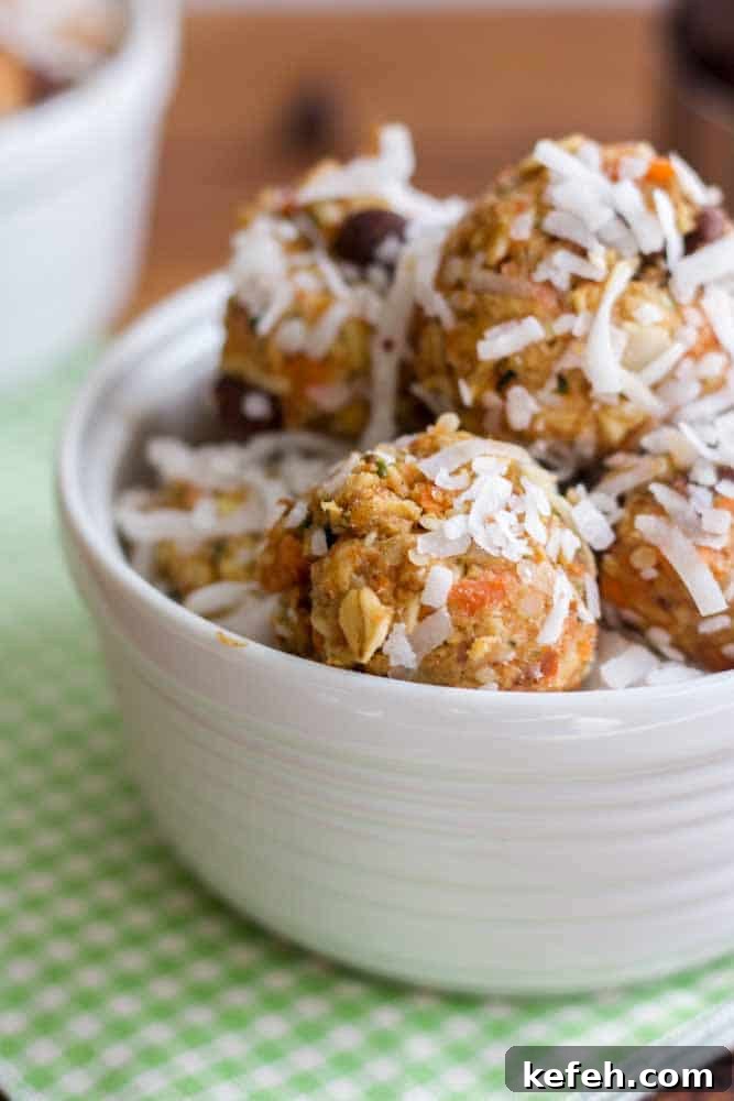 white bowl resting on a green plaid napkin filled with carrot cake energy balls covered in coconut flakes