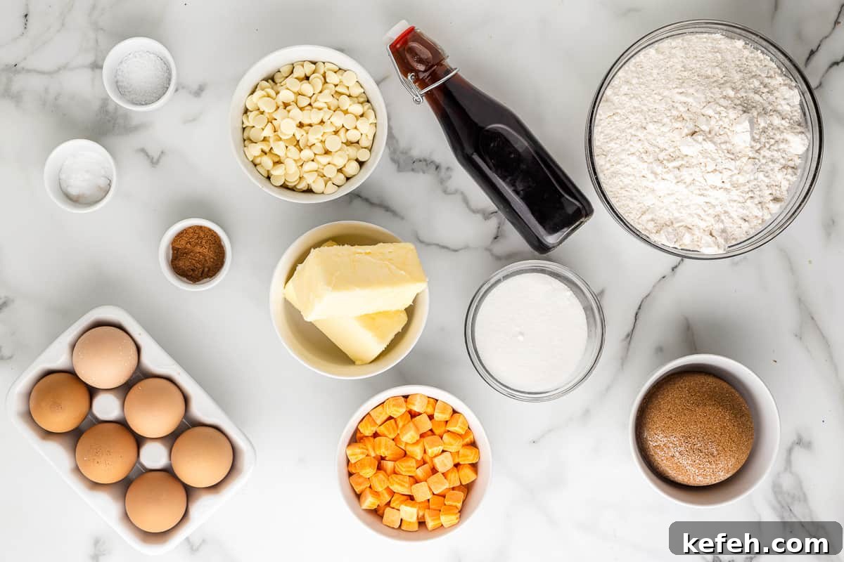 ingredients for pumpkin spice cookies: flour, brown sugar, eggs, vanilla, white chocolate chips, pumpkin chips, butter.