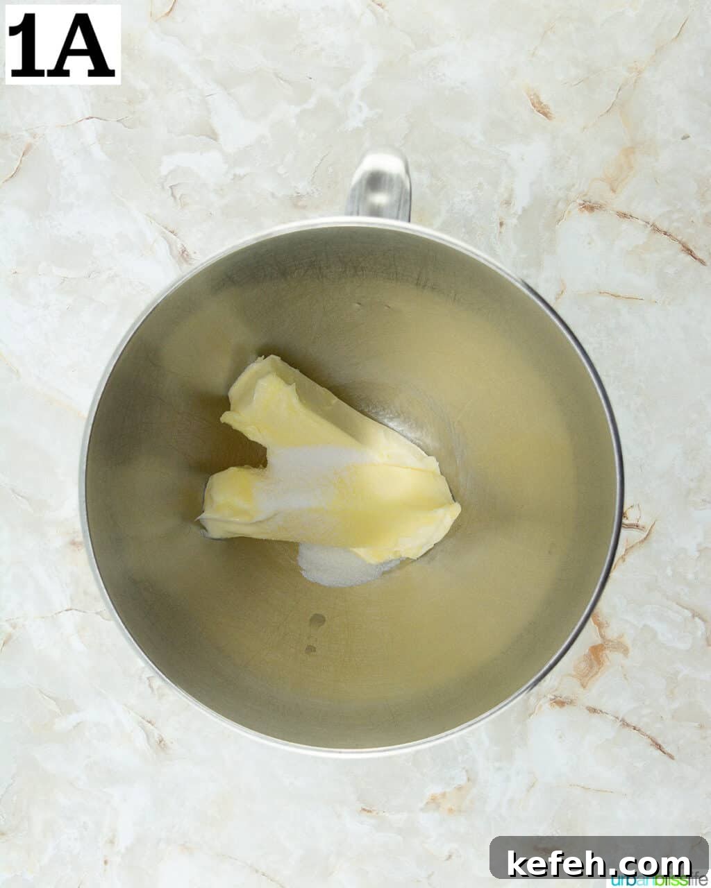 butter and sugar in a stainless steel stand mixing bowl.