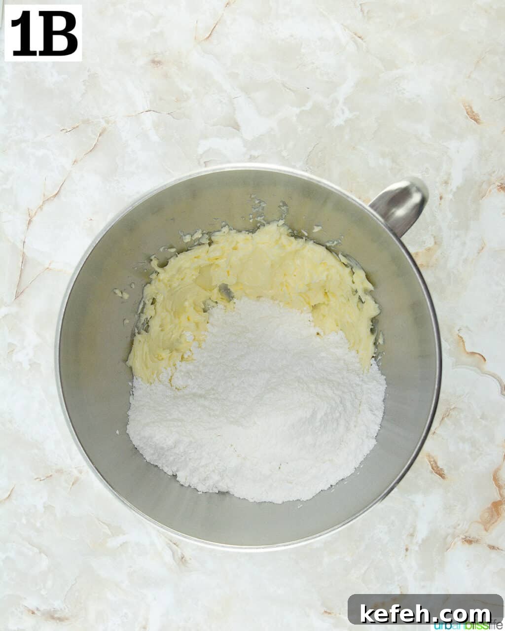 butter and sugar in a stainless steel stand mixing bowl.