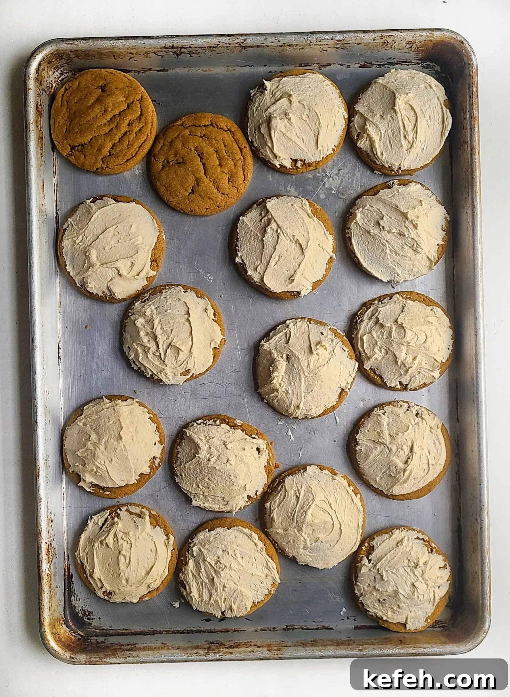 adding the buttercream to the pumpkin spice latte cookies