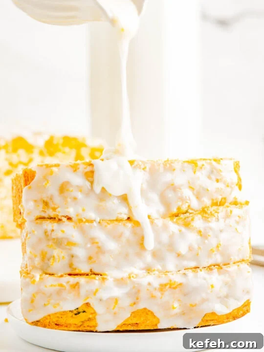 Three glazed lemon zucchini bread slices on a plate.