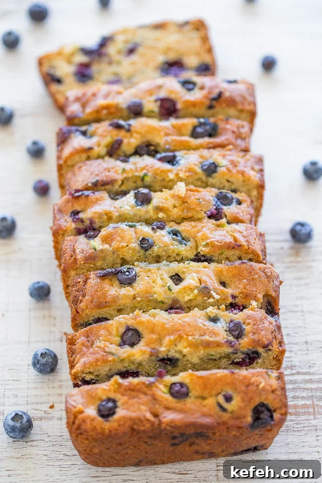 A loaf of Blueberry Zucchini Bread loaf sliced into pieces. 