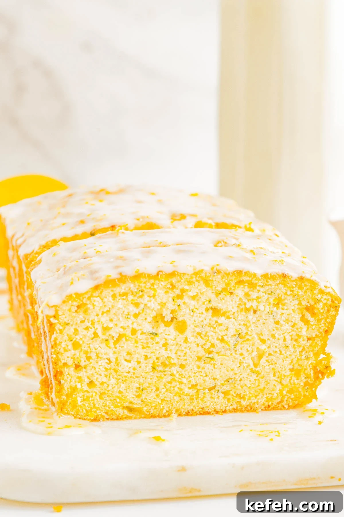 Glazed Lemon Zucchini Bread - This EASY, no-mixer homemade quick bread combines tangy lemon flavor with tender zucchini which keeps it so incredibly soft, tender, and moist! Topped with a simple lemon glaze, this bread is not overly sweet. It's PERFECT for breakfast, brunch, as a snack, or as a lighter summer dessert!