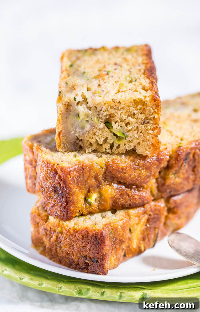Three slices of zucchini banana bread on a plate. 