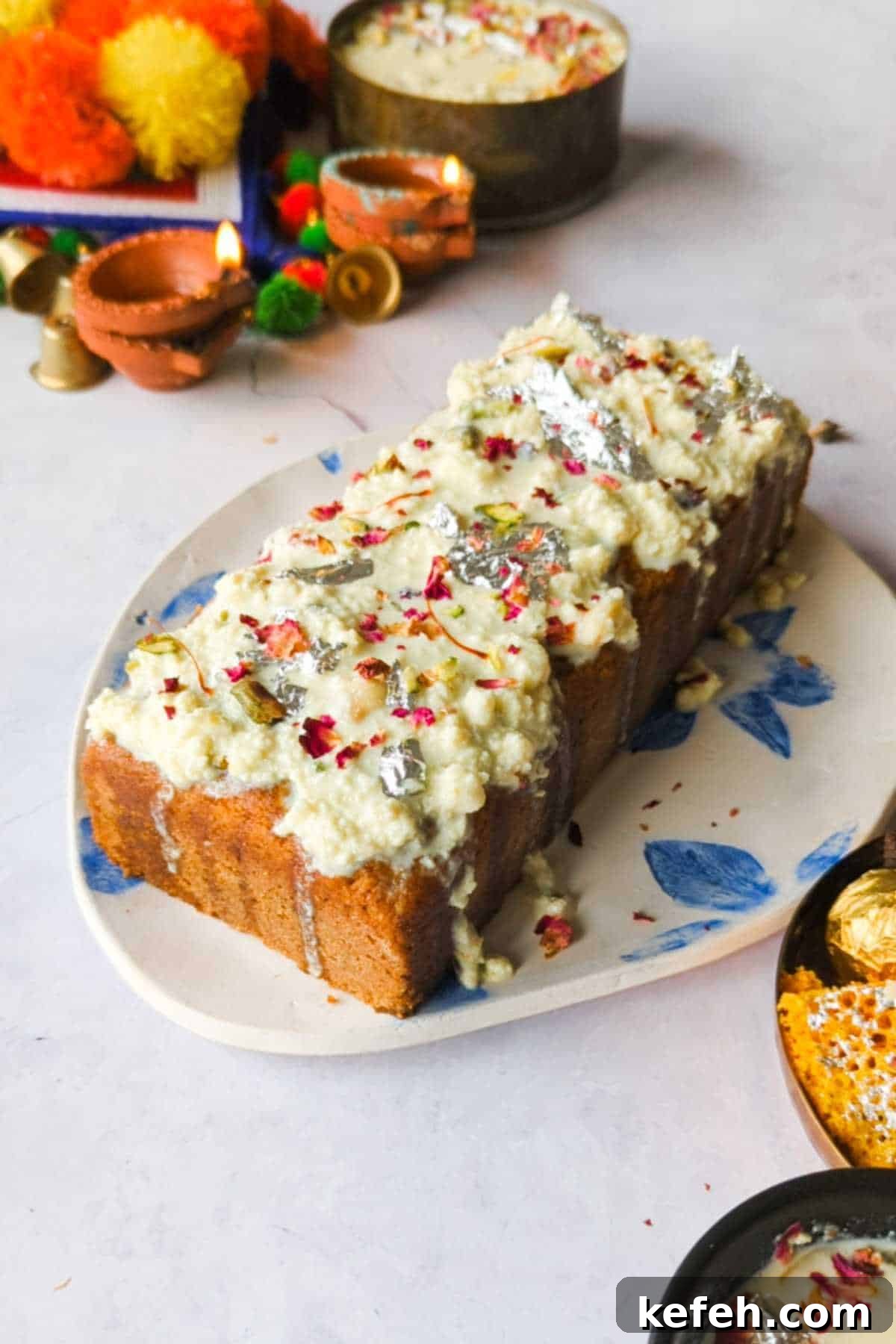 Eggless Gulab Jamun Mix Cake with Creamy Rabdi Recipe 3 gulab jamun mix loaf cake adorned with instant rabdi placed on a white and blue plate