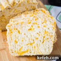 Cheddar Beer Bread Recipe: Rustic Cheesy Loaf 2 Close up of two slices of beer bread leaning against a loaf of bread
