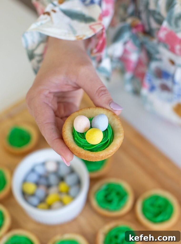 Easter Nest Cookie Cups Recipe 5 Easter birds nest cookie cup with green frosting for grass, and chocolate eggs.