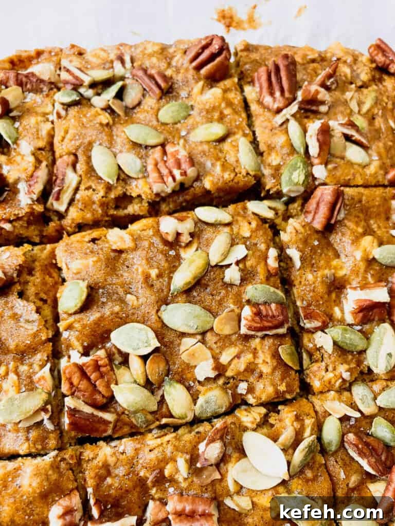 Pumpkin Oatmeal Breakfast Bars 3 Oatmeal pumpkin bars topped with nuts and seeds.