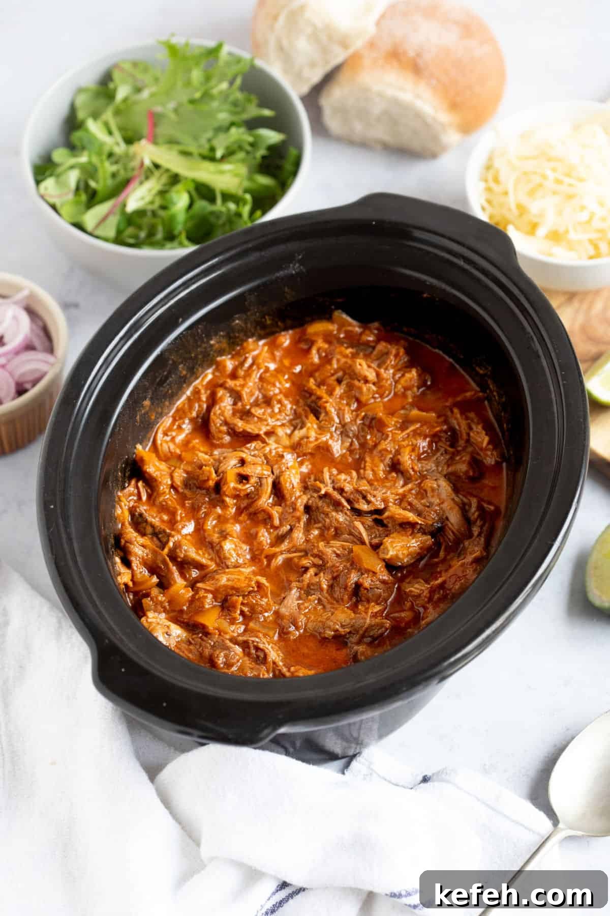 Slow Cooker Pulled Beef Recipe for Tender, Shredded Meat 2 Slow cooker pulled beef in a slow cooker basin.