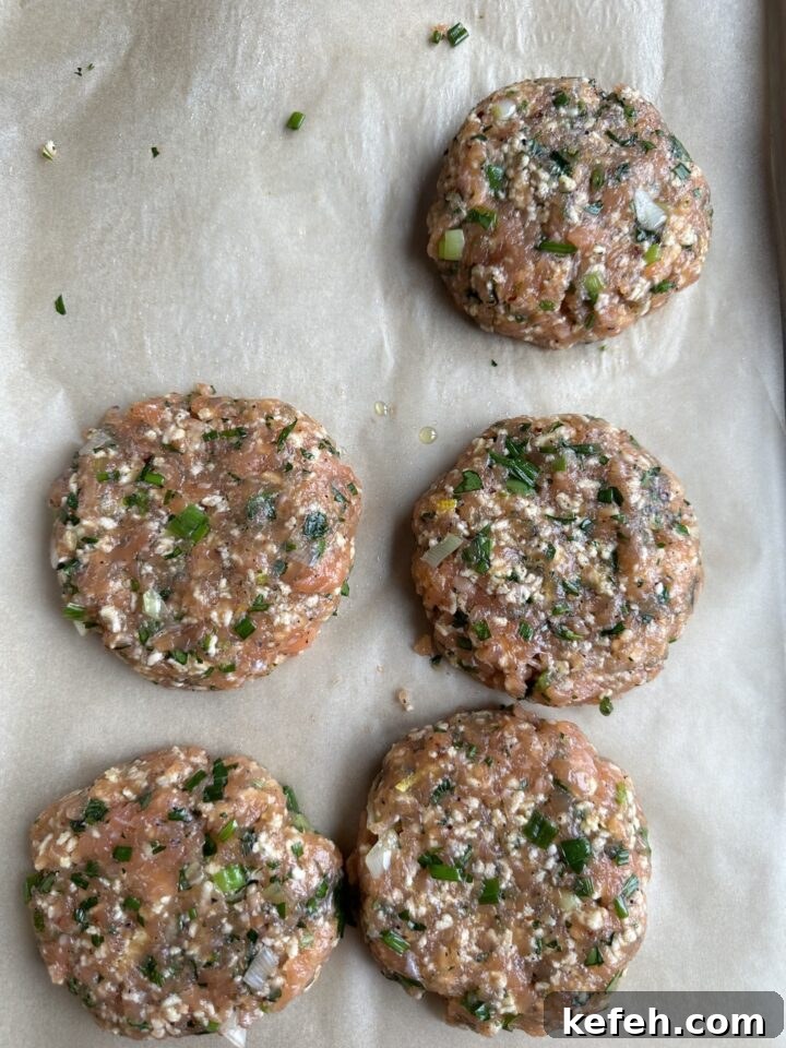 Middle Eastern Salmon Burger Recipe with Zaatar and Tahini 11 salmon burger patties on parchment paper