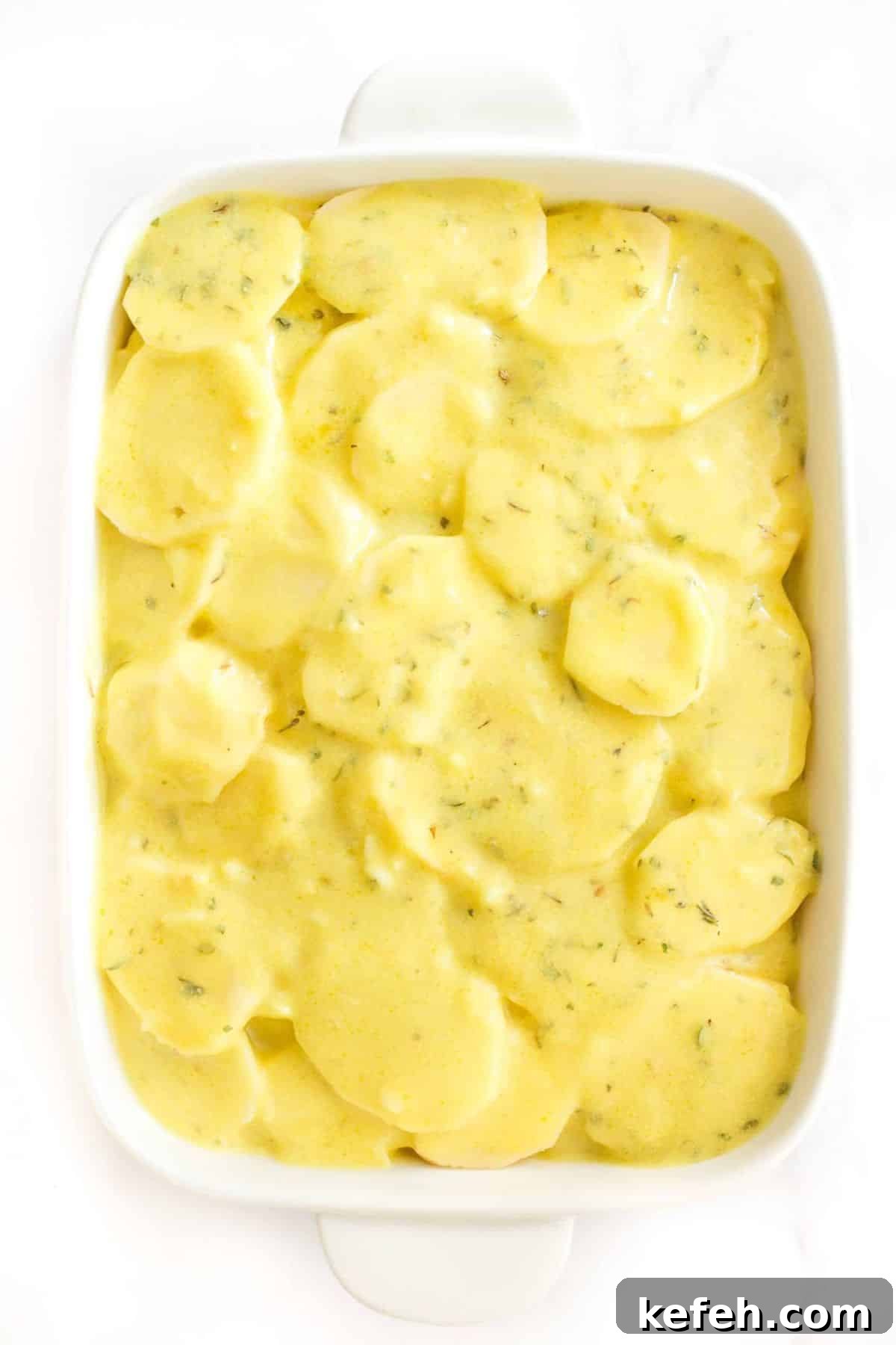 Creamy Gluten-Free Scalloped Potatoes (Dairy-Free, Vegan) Scalloped potatoes about to be baked.