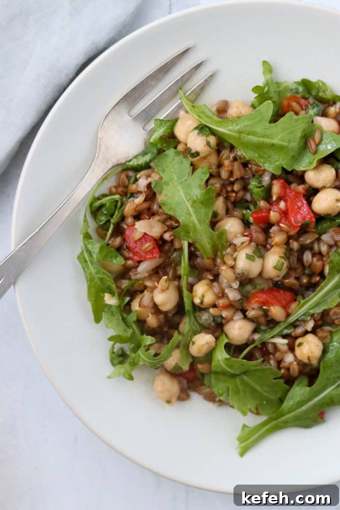 Rye Berry Salad with Chickpeas, Roasted Red Peppers and Arugula 6 rye berry and chickpea with arugula on a plate