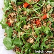 Rye Berry Salad with Chickpeas, Roasted Red Peppers and Arugula 9 Rye berry salad with roasted peppers and arugula on a platter