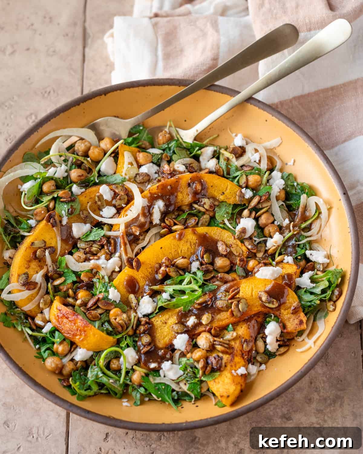 Vegan Holiday Survival Guide: Thrive at Festive Meals 12 Side view of pumpkin salad on a yellow plate on a tan table.