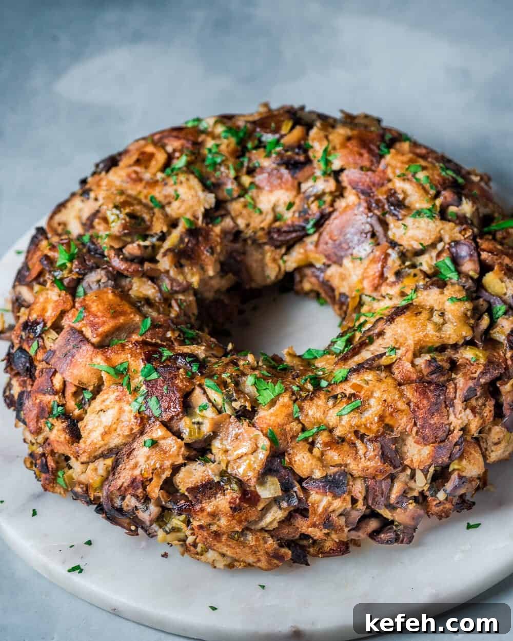 Vegan Holiday Survival Guide: Thrive at Festive Meals 13 wild mushroom stuffing on a marble serving board.