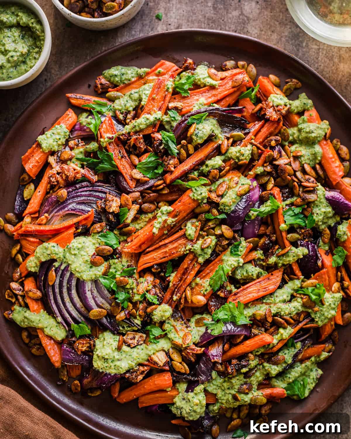 Vegan Holiday Survival Guide: Thrive at Festive Meals 14 big plate of roasted carrots, red onions and dates covered in pesto.