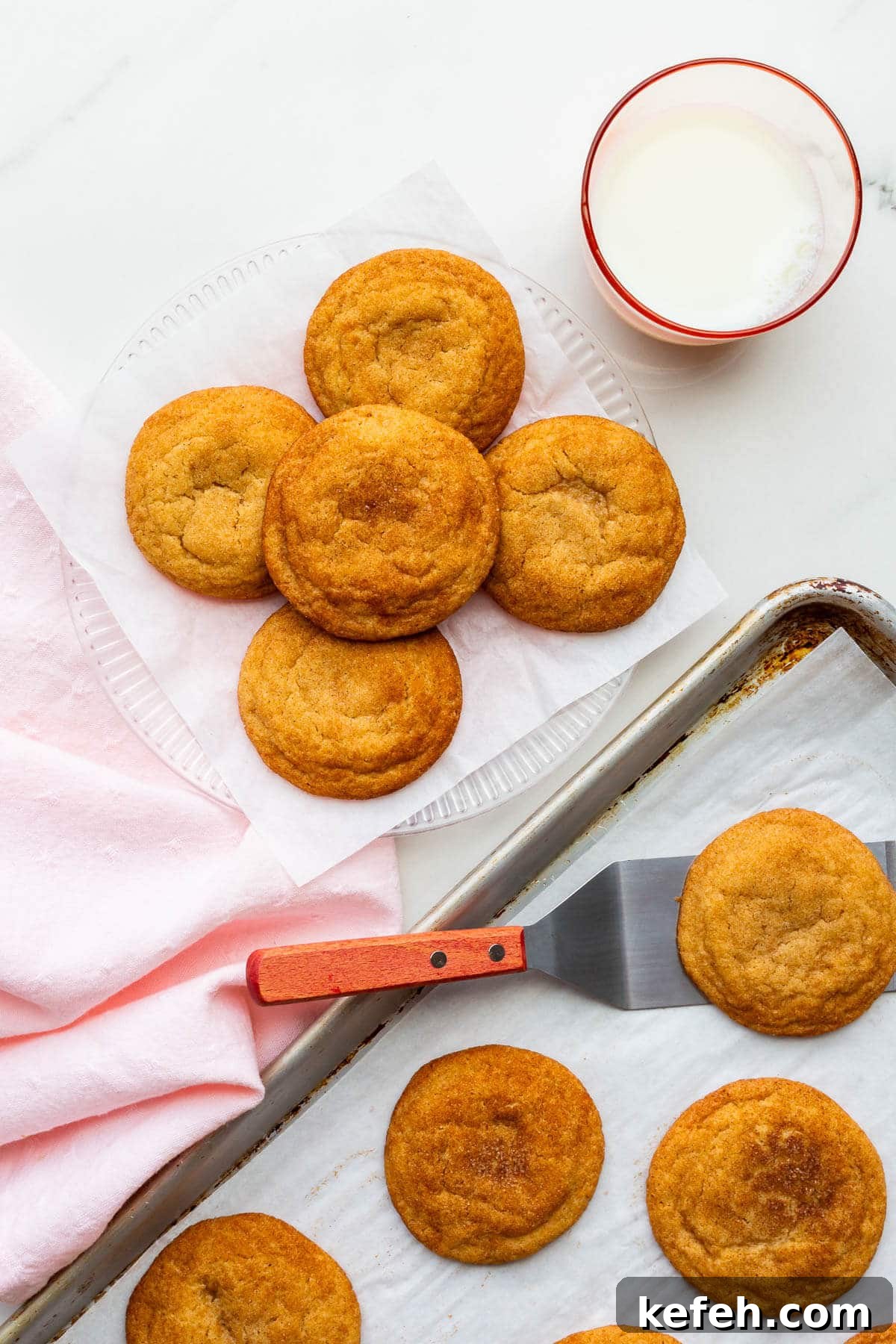 Classic Cinnamon Sugar Snickerdoodle Cookies 2 Transferring freshly-baked homemade snickerdoodles to a plate to serve them.
