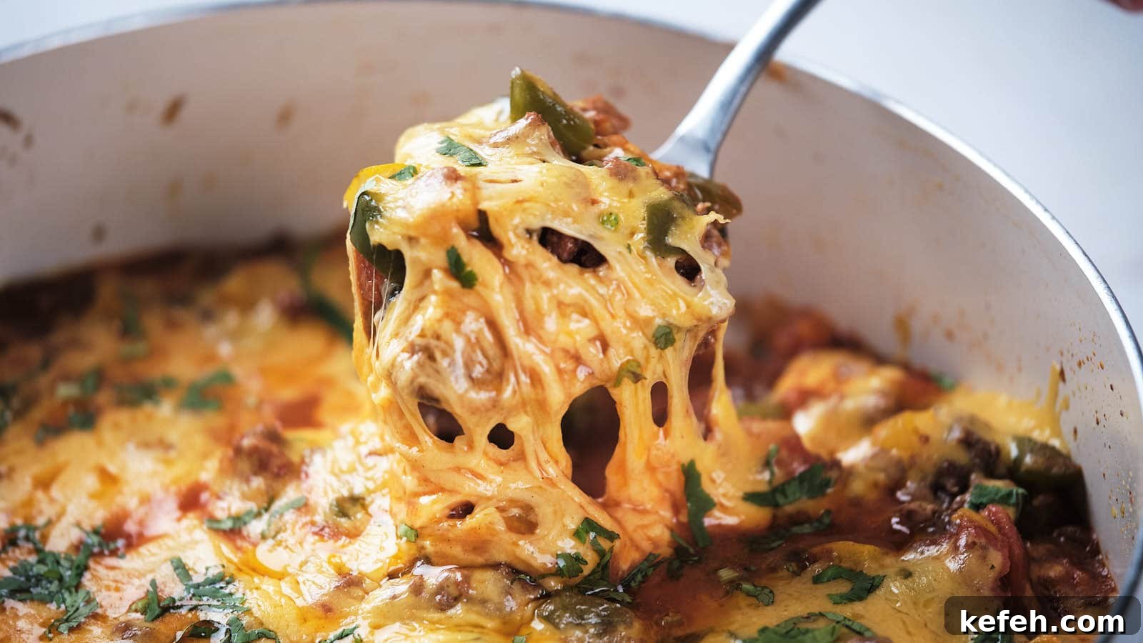 25 Low-Carb Dinners Even Carb Lovers Can't Resist 13 A close-up of ground beef taco skillet being served with a metal spoon.