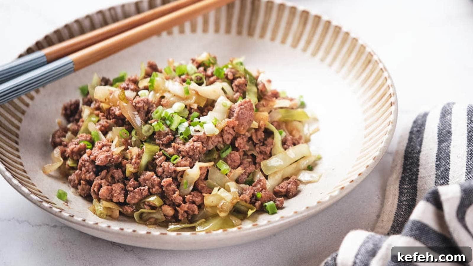 25 Low-Carb Dinners Even Carb Lovers Can't Resist 22 Ground beef and cabbage stir fry being scooped out from a skillet.