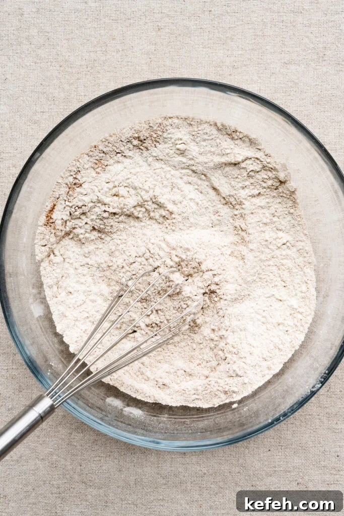 Classic Moist Gingerbread Cake Recipe 3 Overhead of flour and spices mixed together in a bowl.