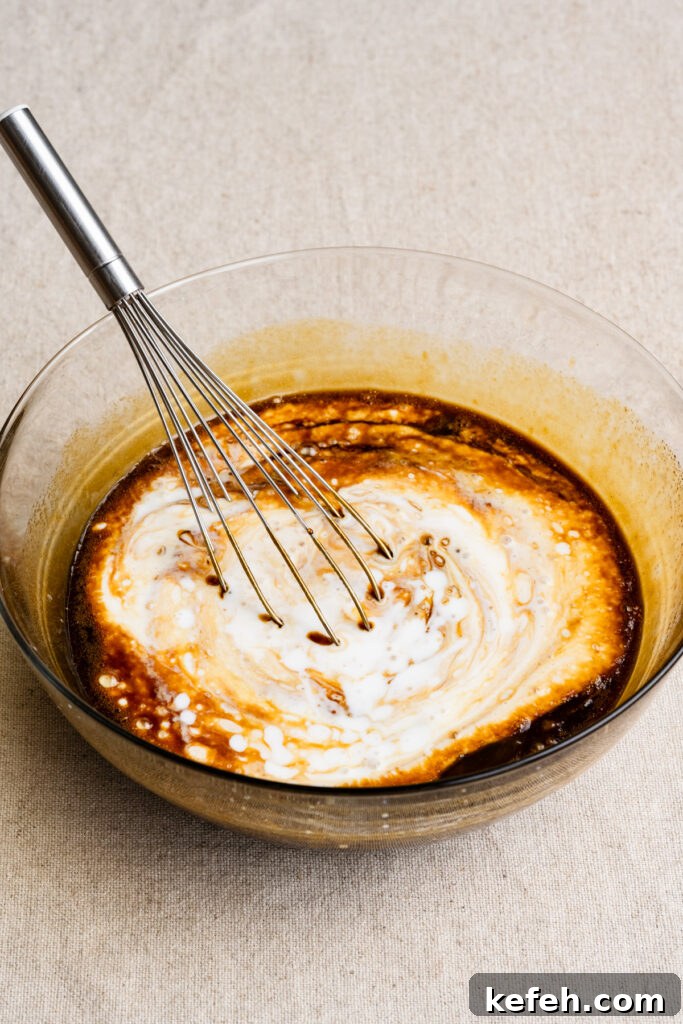 Classic Moist Gingerbread Cake Recipe 5 Whisk in a bowl of buttermilk and molasses cake batter.