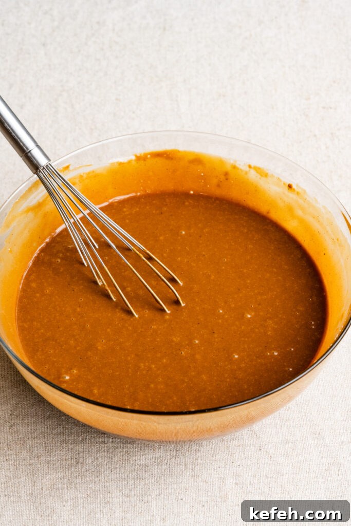 Classic Moist Gingerbread Cake Recipe 8 Gingerbread cake batter in a mixing bowl with a whisk.